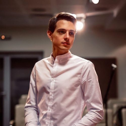 Aleksei Vyzhanov, Artistic Director of Inplay School of Music, near the piano